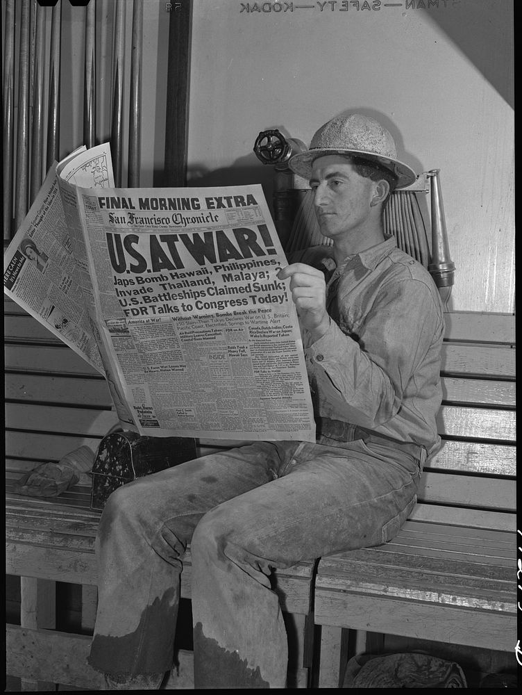 Workman at Shasta Dam reads war extra. Shasta County, California by Russell Lee
