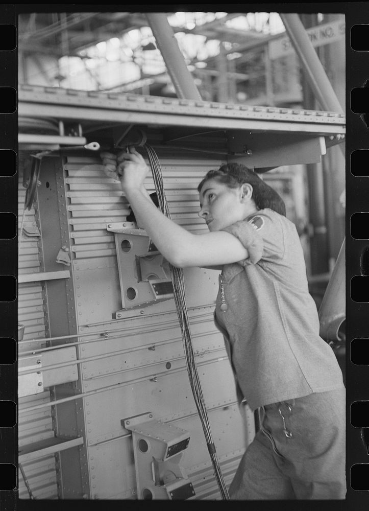 Nashville, Tennessee. Vultee Aircraft Company. Installing electric wiring in a fuselage. Sourced from the Library of…