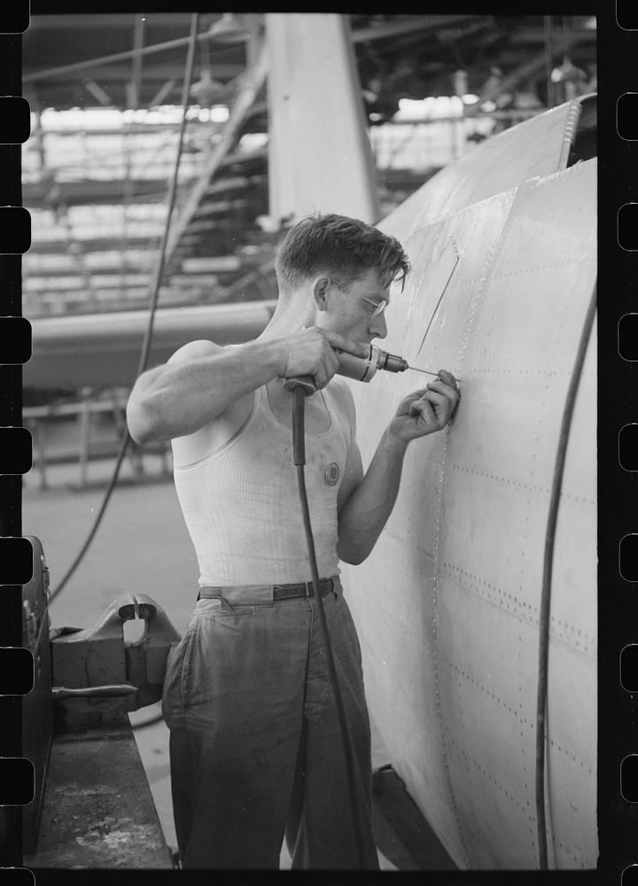Nashville, Tennessee. Vultee Aircraft Company. Drilling holes for rivets in a fuselage in a sub-assembly line. Sourced from…