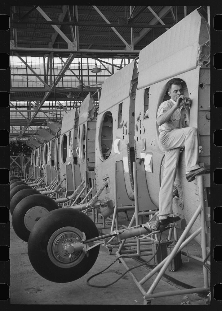 Nashville, Tennessee. Vultee Aircraft Company. Installing landing gear on wing parts in a sub-assembly section. Sourced from…