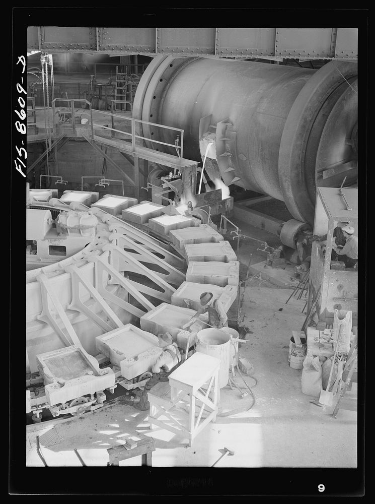 Anaconda smelter, Montana. Anaconda Copper Mining Company. Pouring copper anodes from the refining furnace; forms are…