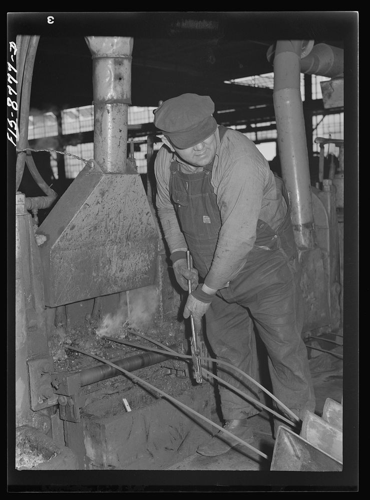 Great Falls, Montana. Anaconda Wire and Cable Company. Workmen putting unfinished rod into rolls of a finishing mill; from…