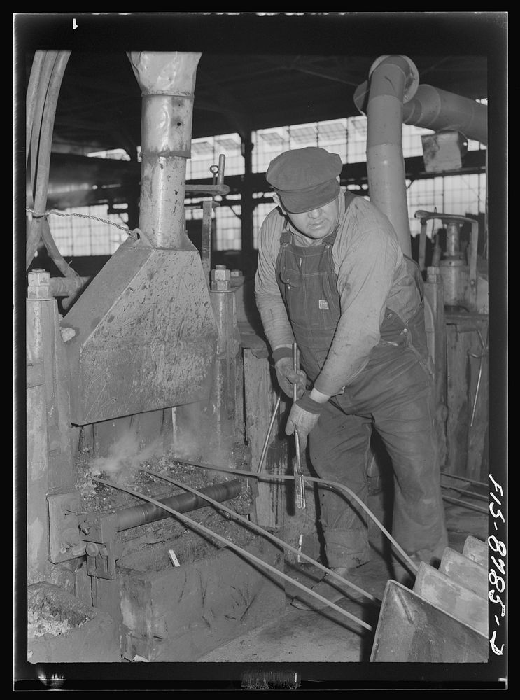 Great Falls, Montana. Anaconda Wire and Cable Company. Workmen putting unfinished rod into rolls of a finishing mill; from…