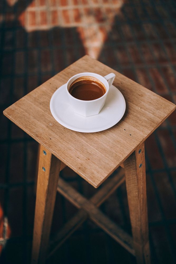 Free coffee cup on wooden stool photo, public domain beverage CC0 image.