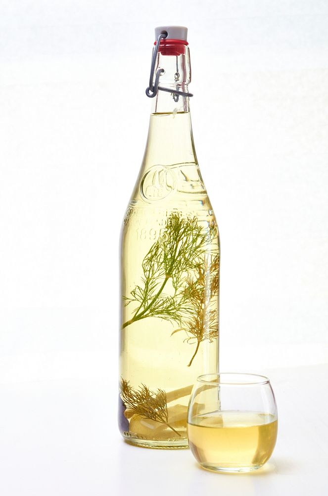Free infused herbs glass bottle photo, public domain beverage CC0 image.