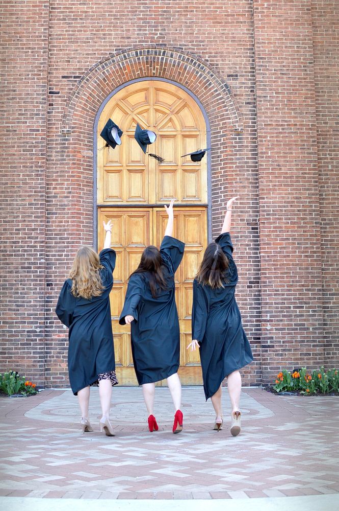 Graduation Girls throwing caps, free public domain CC0 photo.