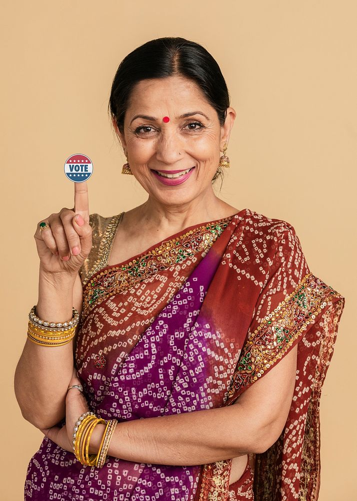 Indian woman showing a vote sticker