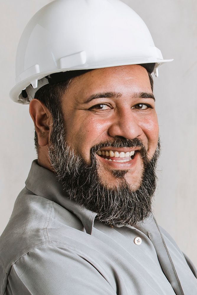 Happy engineer wearing a helmet for protection 