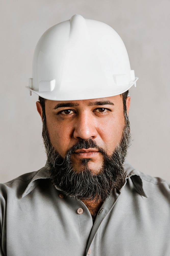 Male Indian engineer wearing a helmet for protection 