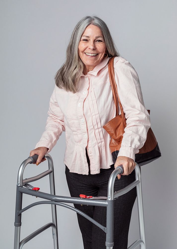 Happy senior woman using a zimmer frame