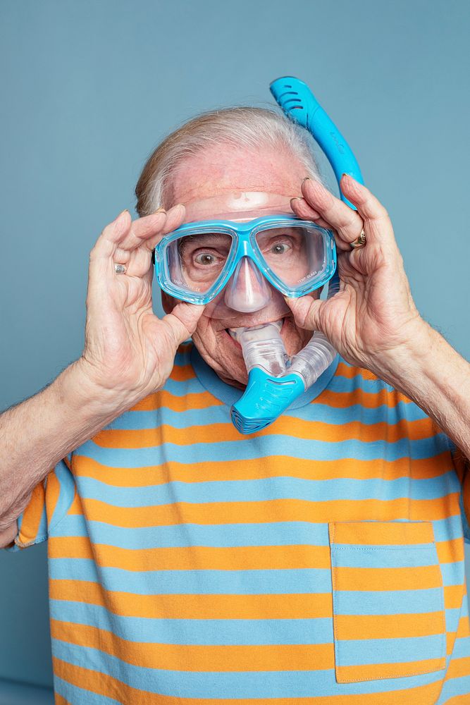 Funny senior man wearing snorkeling goggles