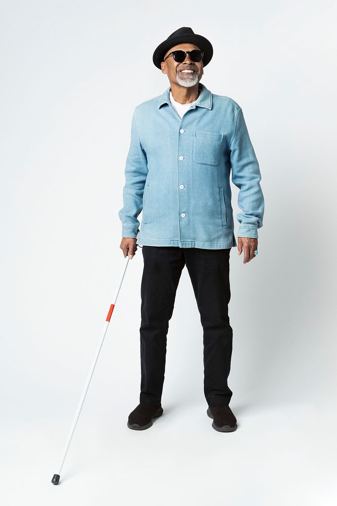 Blind senior man with a cane walking