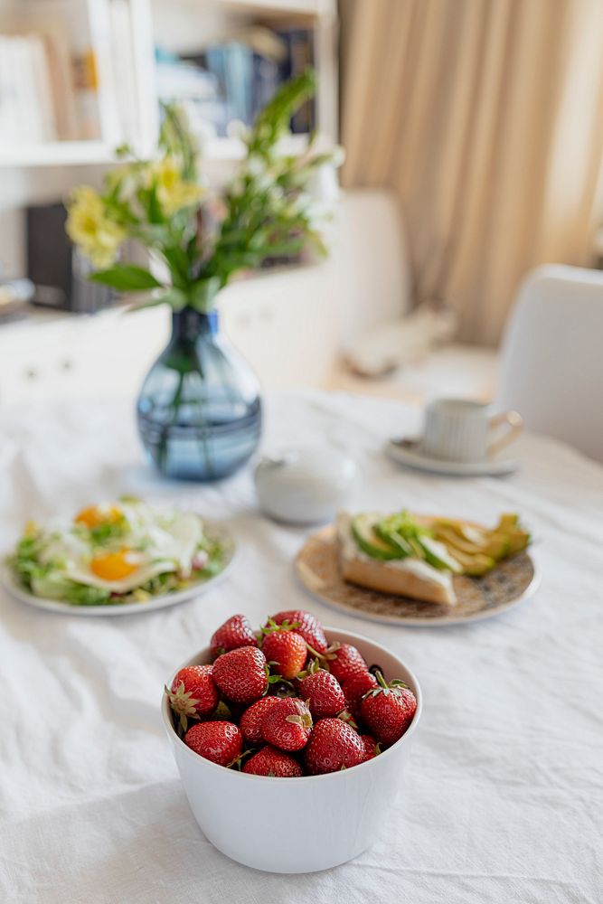 Fresh strawberries with healthy brunch on a dining table