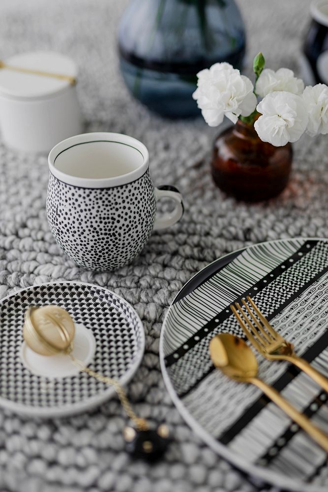 Modern black patterned tableware with gold cutlery