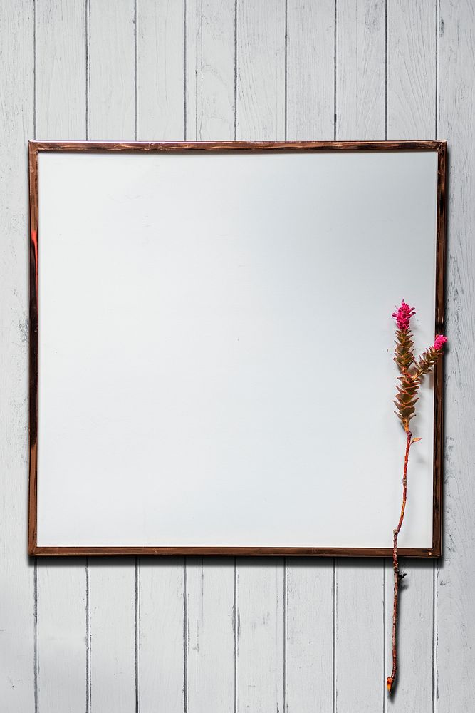 White picture frame mockup on a white wooden wall