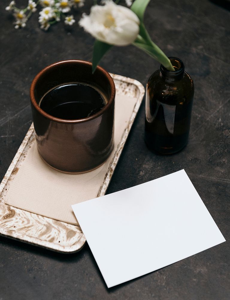 Blank paper by a warm tea glass