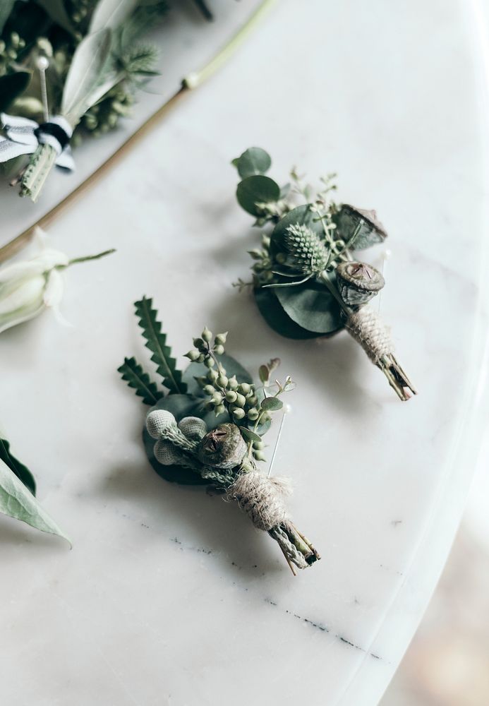 Boutonnieres on a white marble table