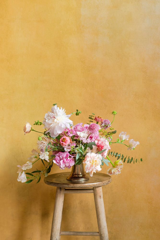 Flowers in a vase on a stool