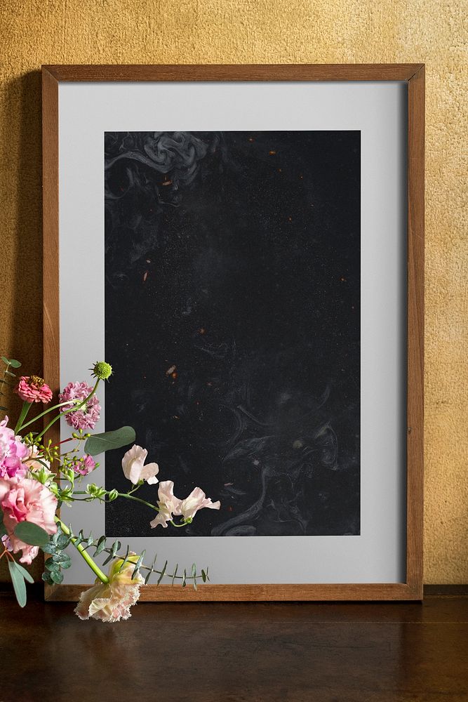 Wooden frame mockup by the flowers