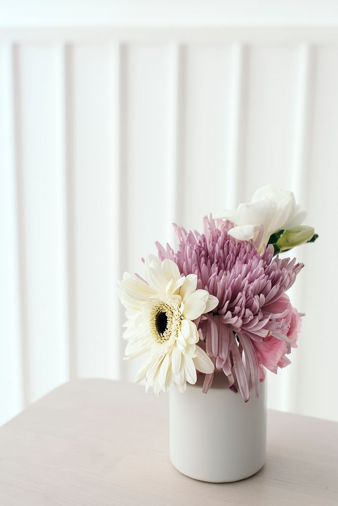 Pink and white flowers in a white vase