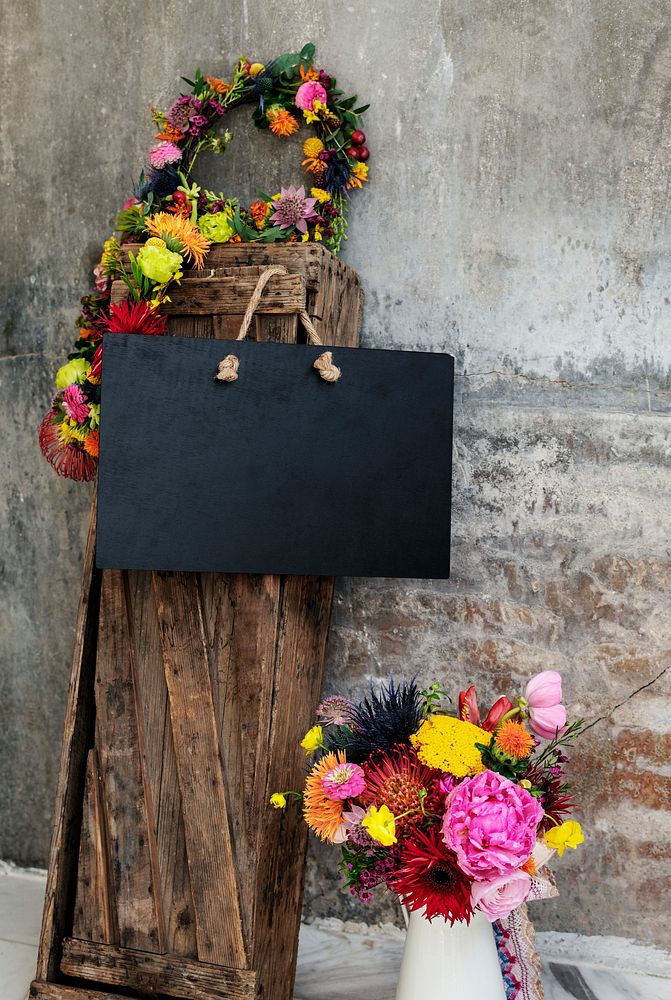 Black blank floral board mockup in a garden