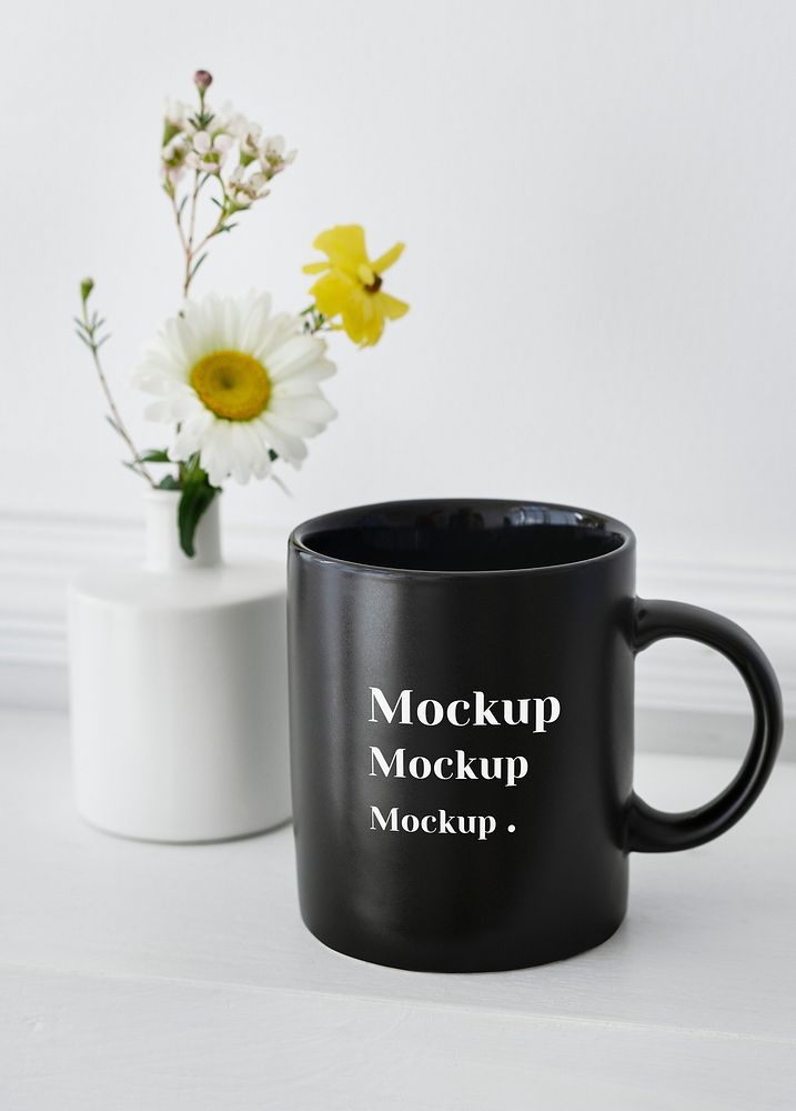 Black coffee cup mockup daisies in a vase