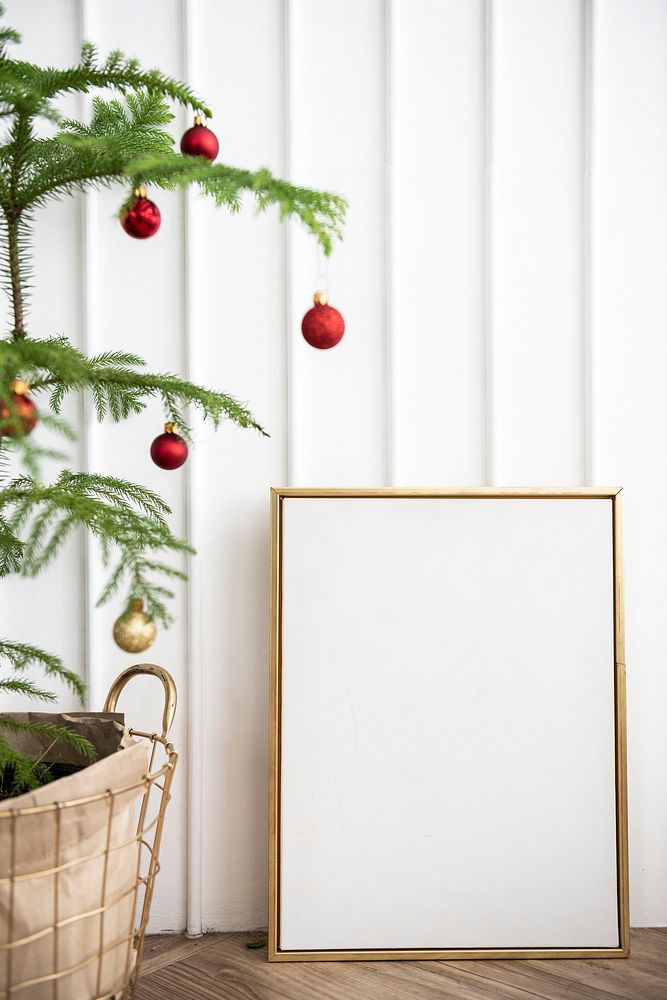 Festive golden frame by a Christmas tree