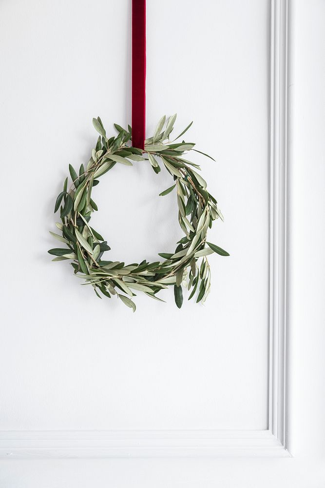Eucalyptus Christmas wreath hanging on a white wall