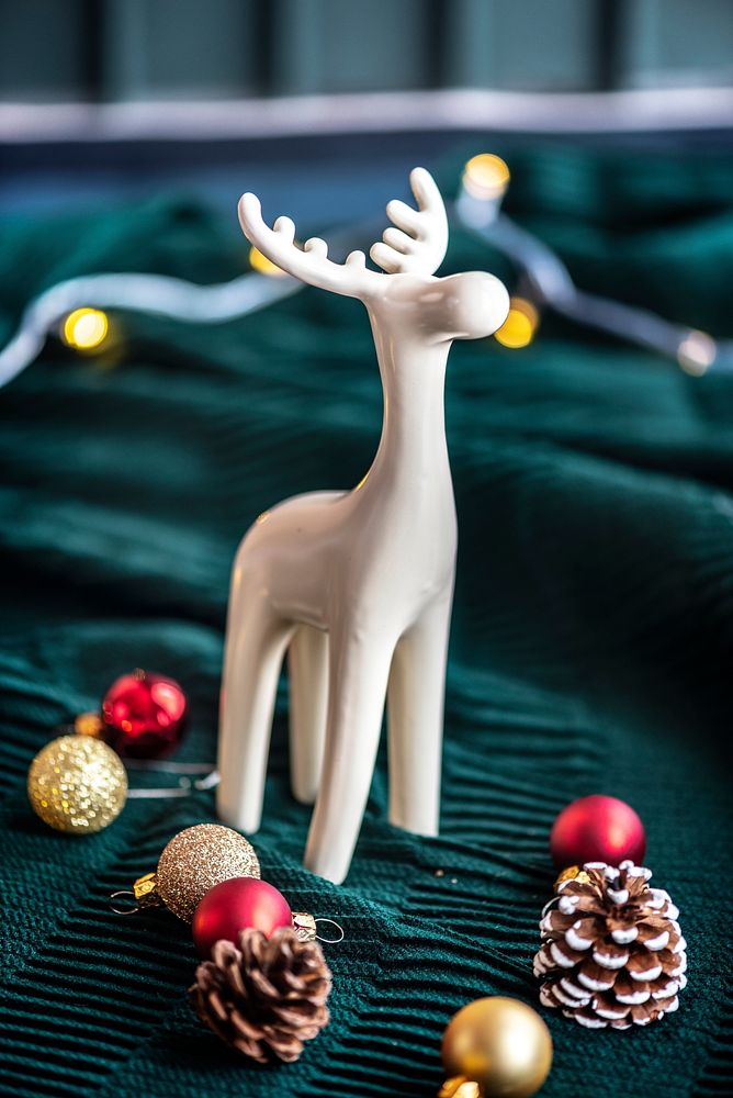 White reindeer surrounded by festive baubles
