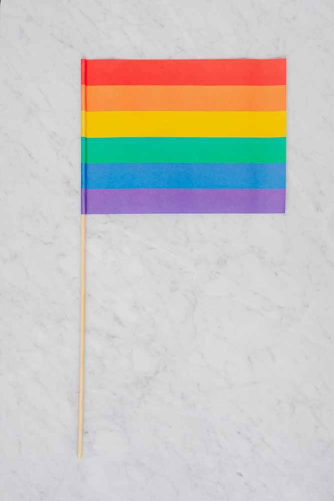 LGBTQ flag on a white marble background