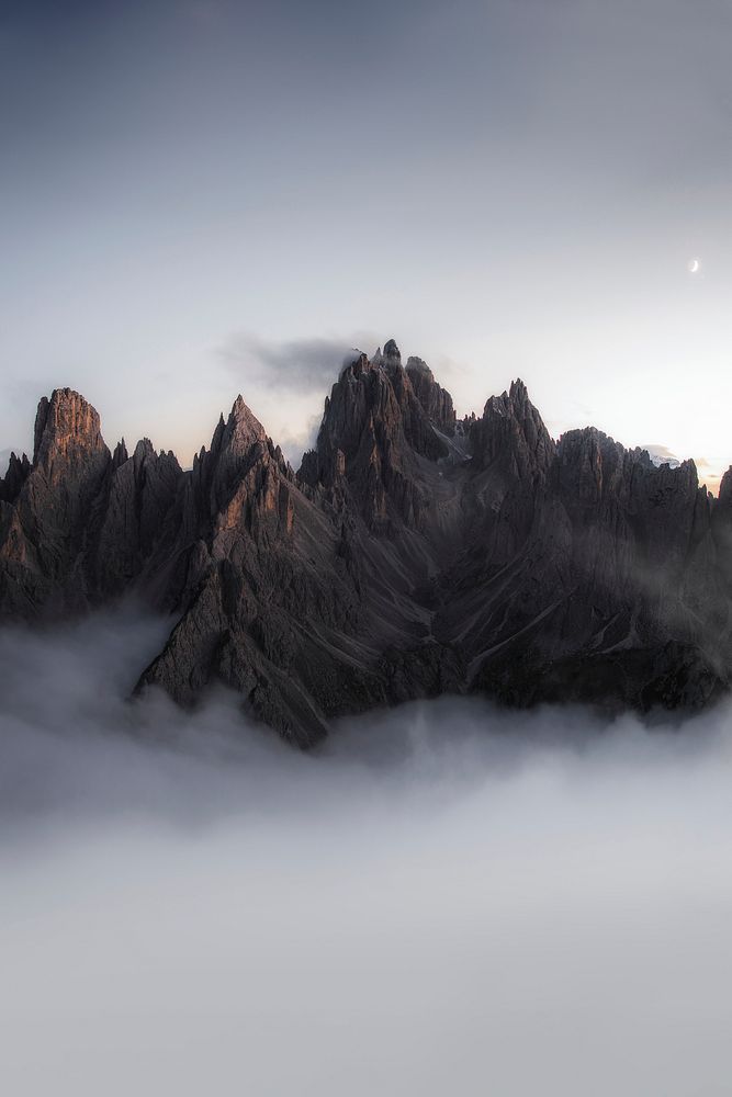 View of foggy Tre Cime di Lavaredo in Dolomites, Italy