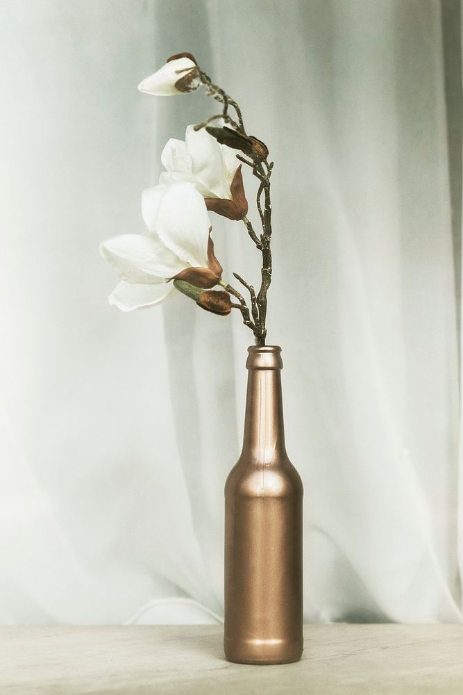 White magnolia in a copper glass bottle