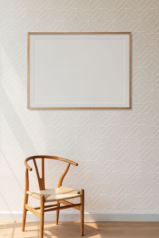 Picture frame mockup hanging above a classic wooden chair