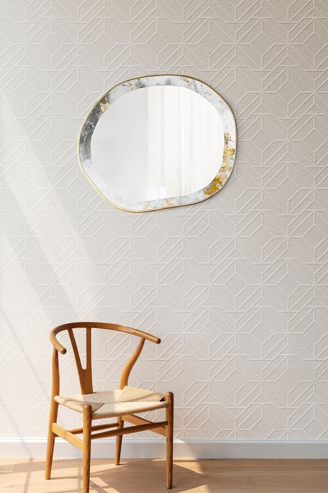 Round mirror hanging on a white wall