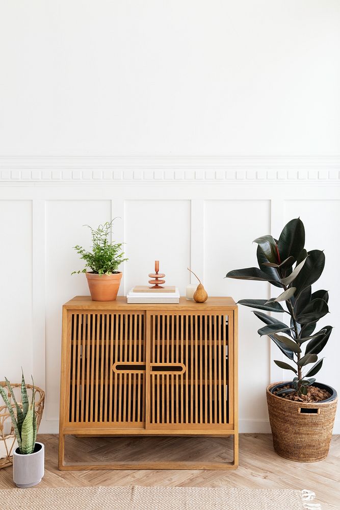 Scandinavian vintage wood cabinet by a white wall