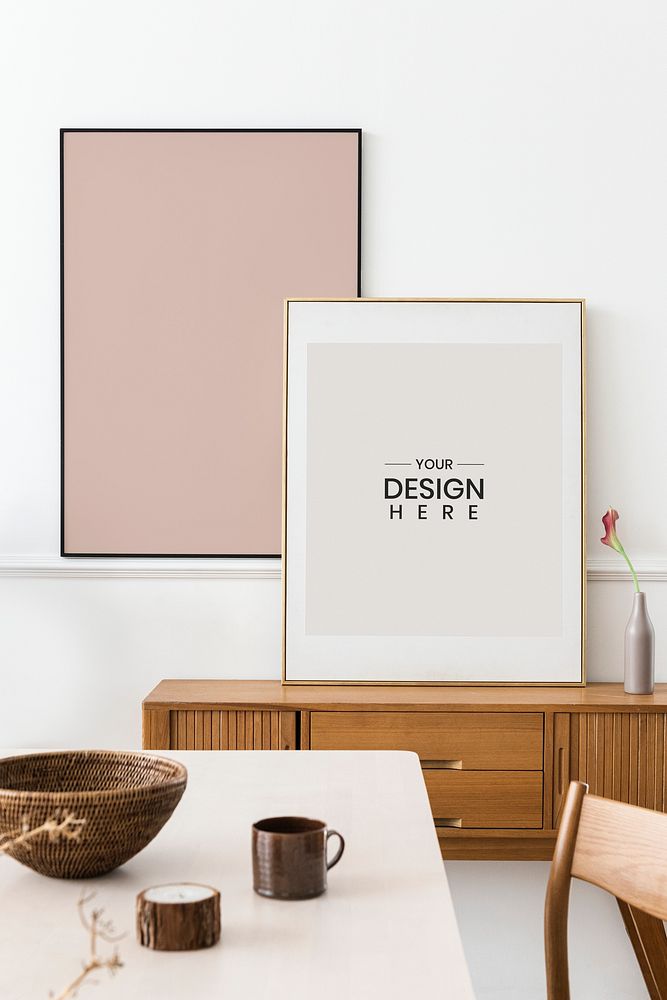 Large photo frame mockups leaning against the wall in a dining room