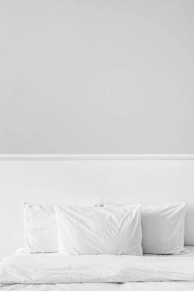 White bed linen in a bed in a bedroom