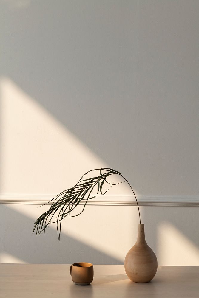 Minimal wooden vase in a white room with a natural light