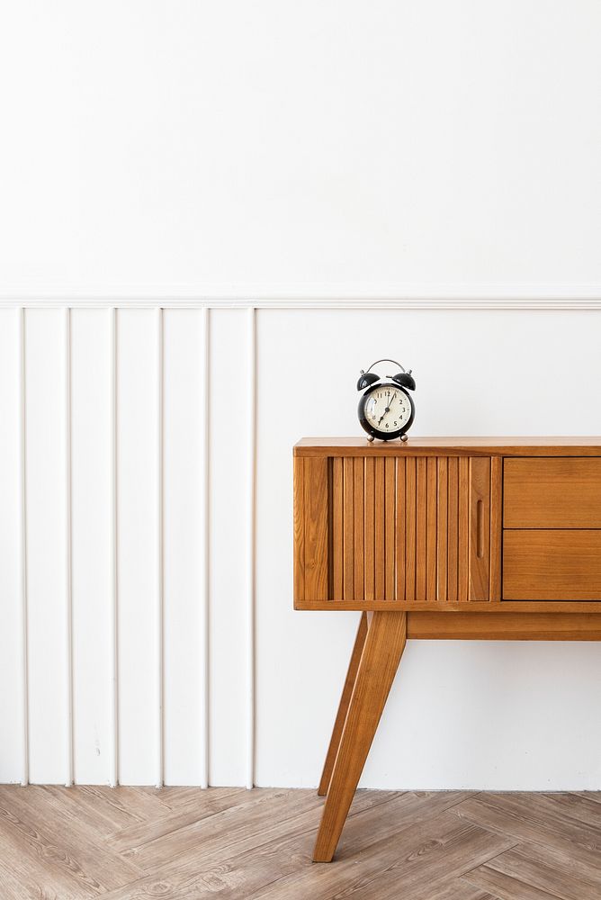 Alarm clock on a wooden sideboard table 