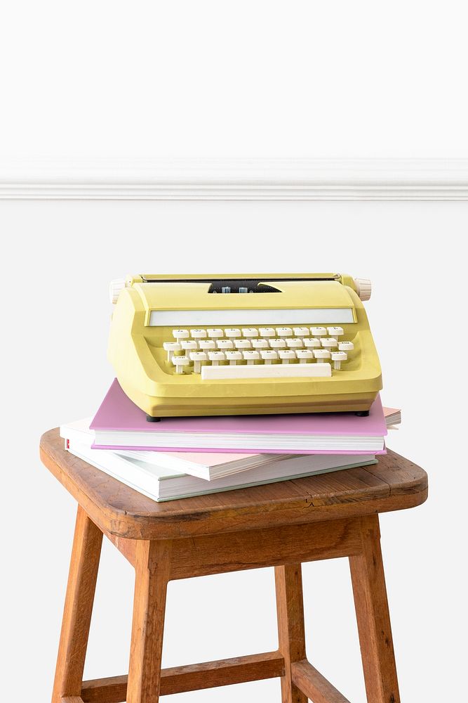 Vintage yellow typewriter mockup on a wooden stool