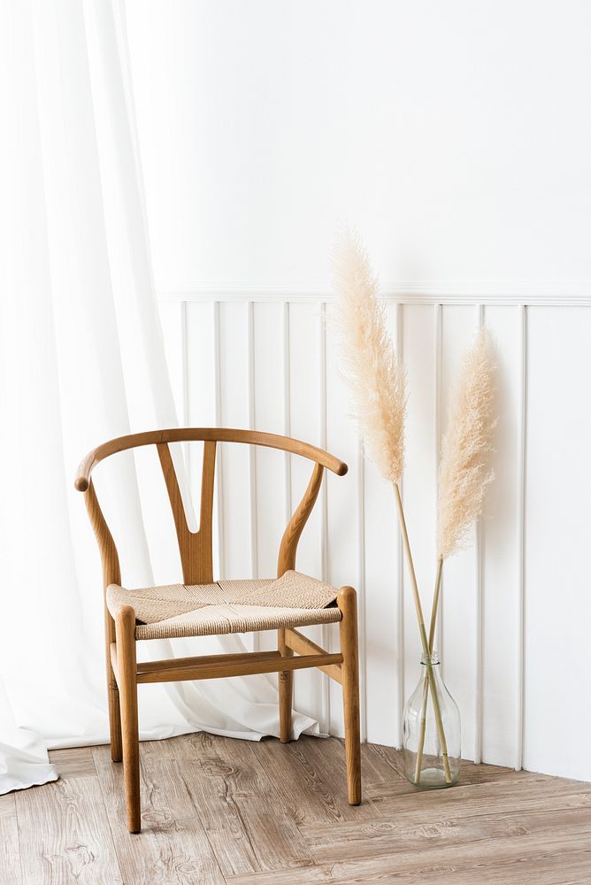 Classic wooden chair by a vase of dry pampas grass