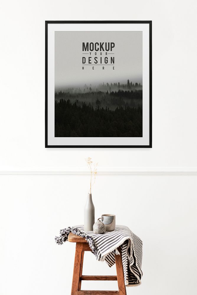 Picture frame mockup hanging over a wooden stool 