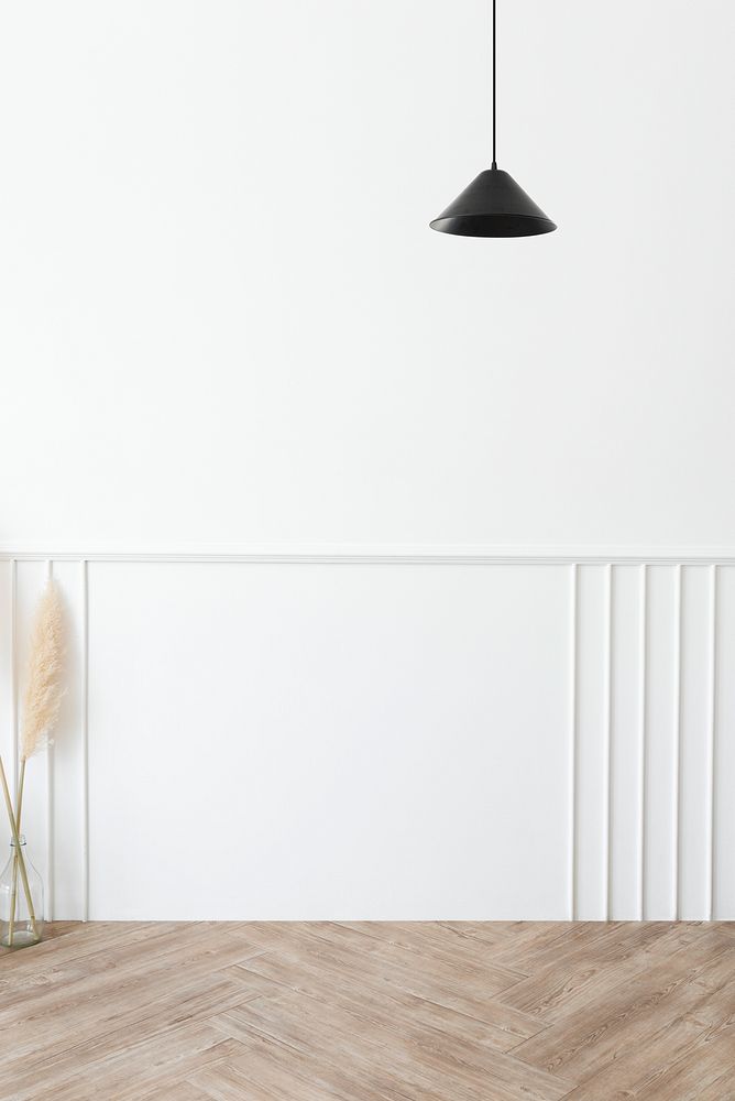 White room with a black pendant lamp