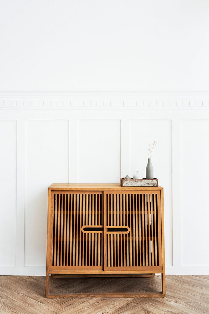 Scandinavian vintage wood cabinet by a white wall