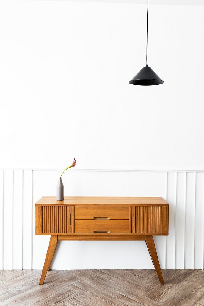 Pendant lamp over a wooden sideboard table