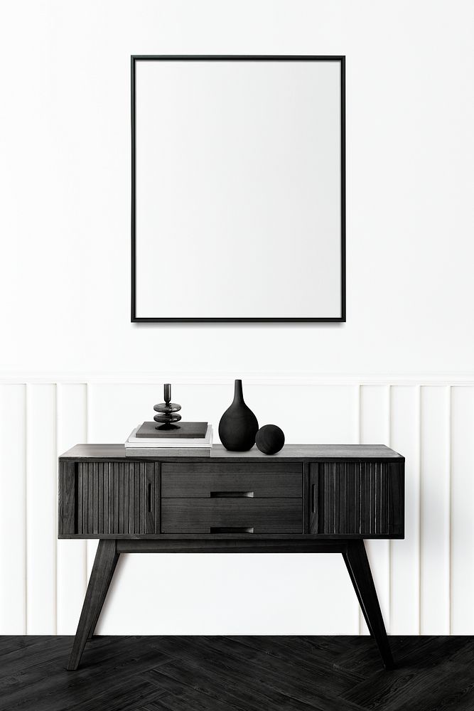 Picture frame above a wooden sideboard