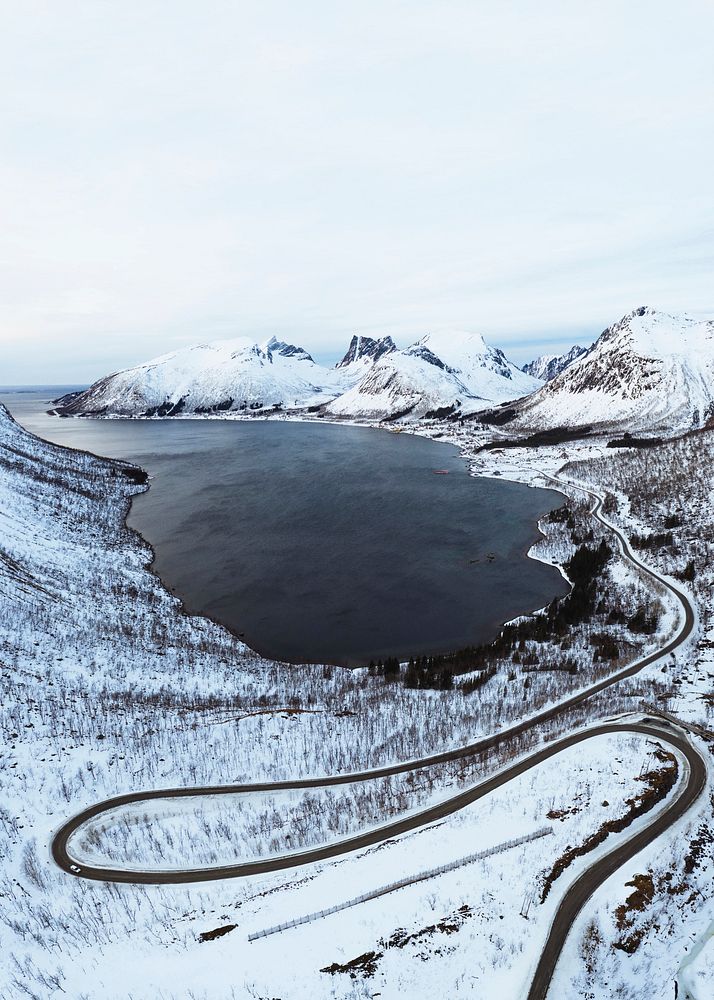 Drone shot of snowy mountains in Norway indented with fjords 