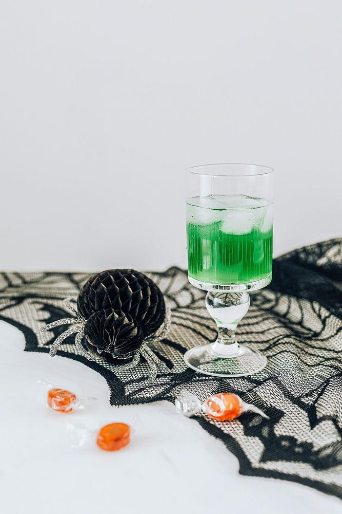 Green Halloween drink on a bat lace tablecloth 