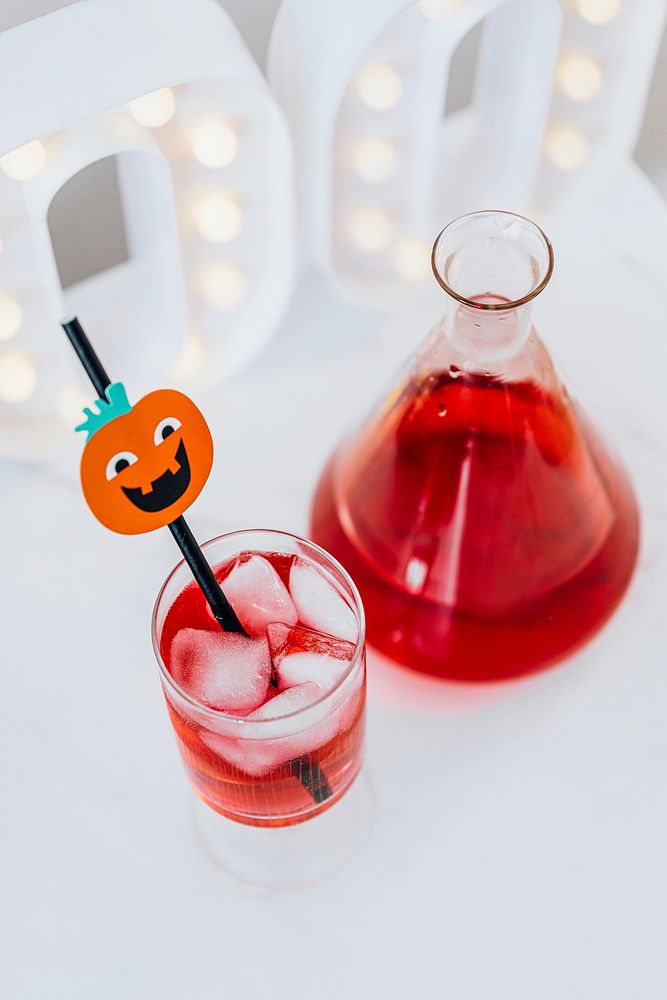 Halloween decoration with a red drink in a glass and a flask