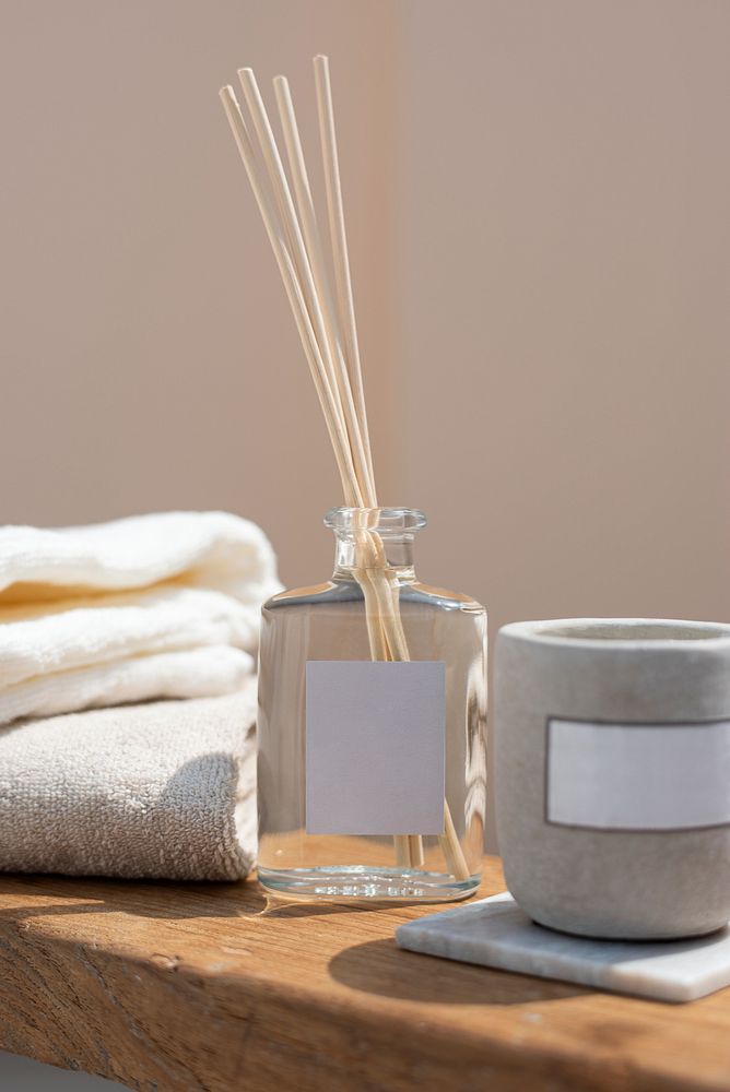 Reed diffuser bottle and aroma candle in a spa